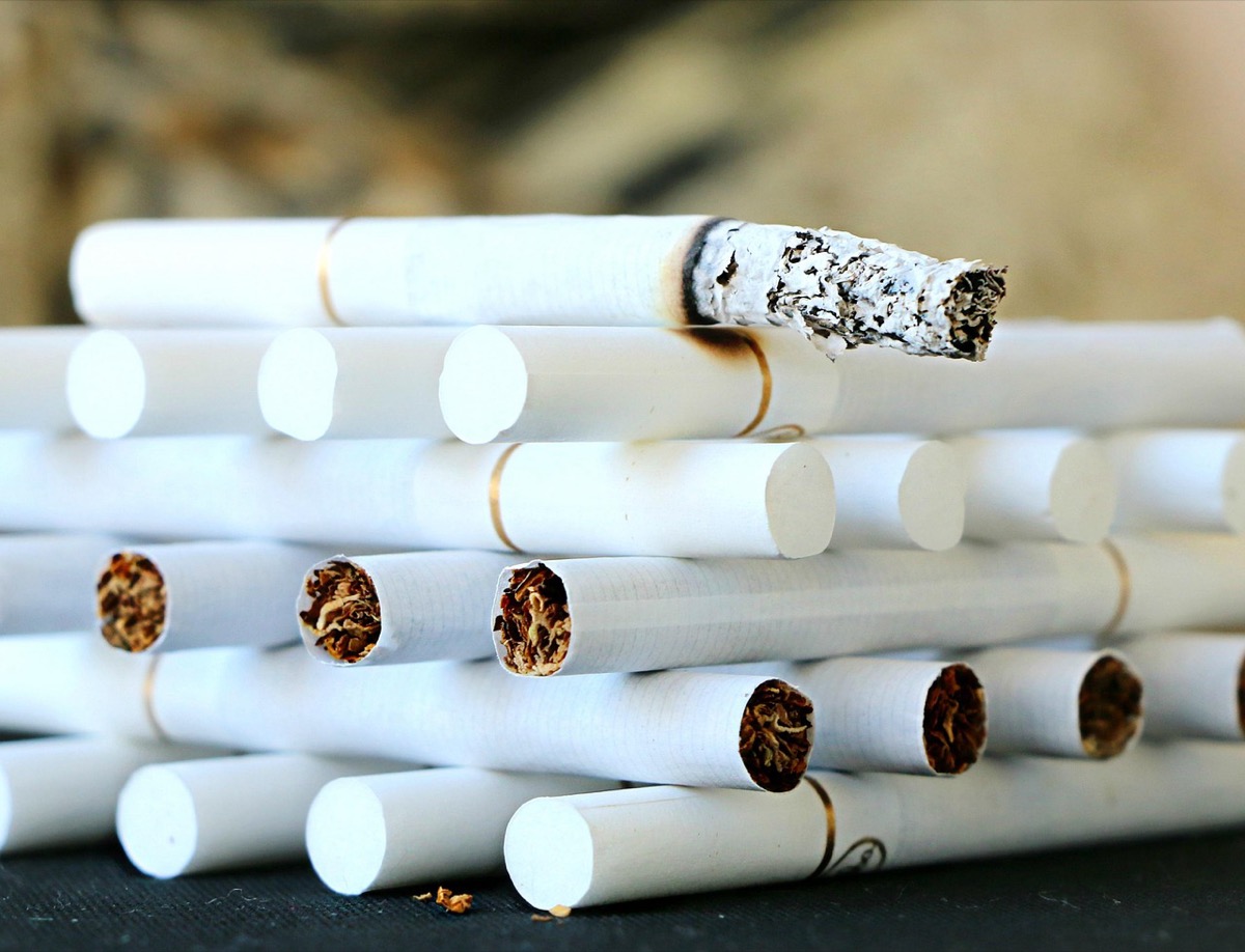 Stacked cigarettes close-up representing tobacco smoke, one of the most challenging indoor air quality problems for HEPA and carbon filters