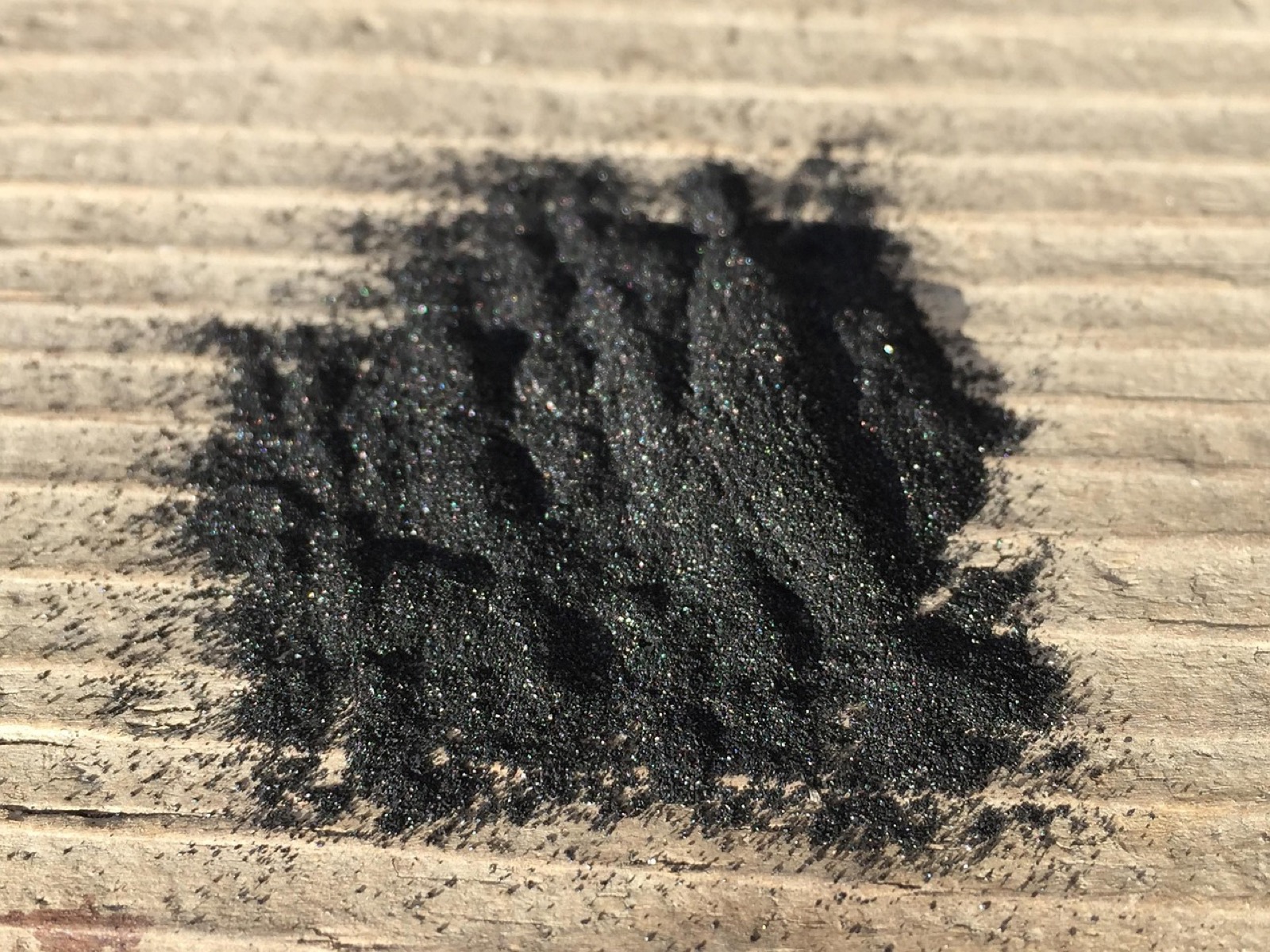 Fine activated carbon powder, representative of the porous carbon media used in odor and gas absorbing air filters